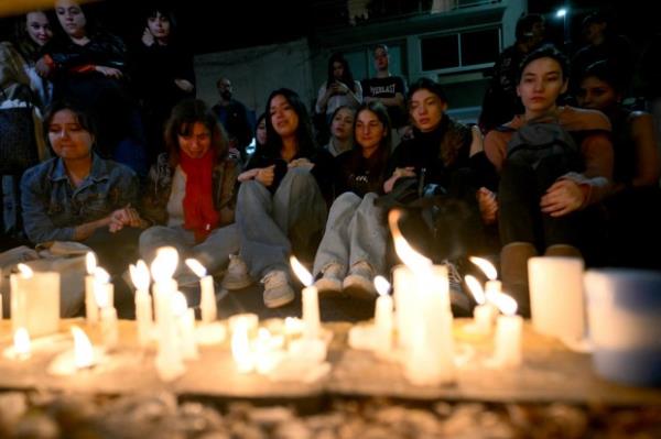 Fans of British singer Liam Payne light candles next to the hotel wher<em></em>e he died in Buenos Aires on October 16, 2024. (Photo by LUIS ROBAYO/AFP via Getty Images)