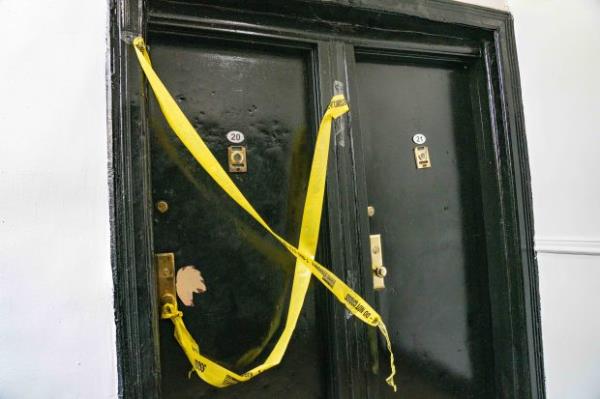 The door to the apartment on Adam Clayton Powell Jr. Blvd. near W. 145th St. is secured as police investigate the death.