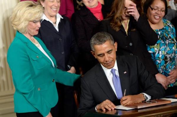 FILE - Lilly Ledbetter watches as President Barack Obama signs executive actions, with pending Senate legislation, aimed at closing a compensation gender gap that favors men, at the White House in Washington, April 8, 2014, during an event marking Equal Pay Day. (AP Photo/Susan Walsh, File)