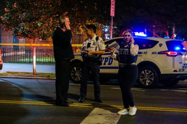 NYPD officers and detectives gather evidence outside the Hamilton Madison Houses on Madison St. in Manhattan, wher<em></em>e two people were shot, Saturday, Oct. 12, 2024. (Jeff Bachner/New York Daily News)