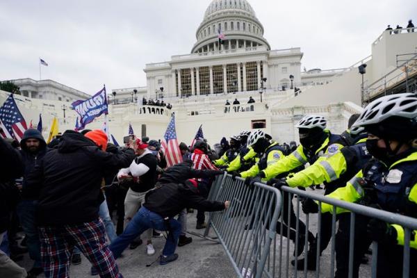 Insurrectio<em></em>nists loyal to President Do<em></em>nald Trump try to break through a police barrier on Jan. 6, 2021, at the U.S. Capitol while both houses of Co<em></em>ngress were meeting to certify the electoral vote.