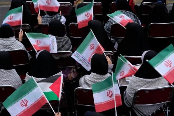 Demo<em></em>nstrators wave Iranian and Palestinian flags in an annual rally in front of the former U.S. Embassy in Tehran, Iran, Sunday, Nov. 3, 2024, marking the 45th anniversary of Iranian students' takeover of the embassy, starting a hostage crisis. (AP Photo/Vahid Salemi)