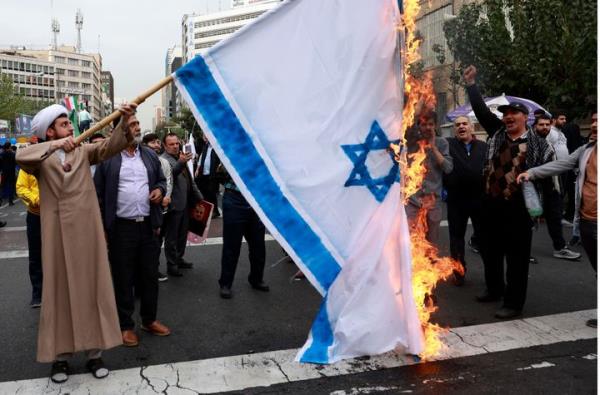 Iranian demo<em></em>nstrators burn a representation of the Israeli flag in an annual rally in front of the former U.S. Embassy in Tehran, Iran, Sunday, Nov. 3, 2024, marking the 45th anniversary of Iranian students' takeover of the embassy, starting a hostage crisis. (AP Photo/Vahid Salemi)