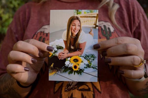 Candace Fails poses for a portrait holding a picture of her late daughter, Nevaeh Crain, at her home in Vidor, Texas on October 24, 2024. Crain passed away on October 29, 2023 at 25 weeks of pregnancy due to preventable causes, including hemorrhaging, after seeking medical help at various hospitals. (Danielle Villasana for ProPublica)