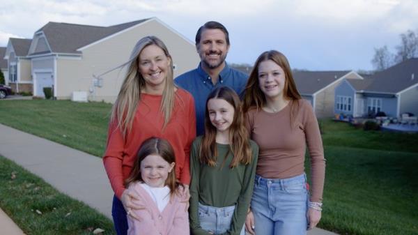 Derrick Anderson, center rear, poses in a holiday card-style image shared by his campaign — but he's standing with someone else's family.