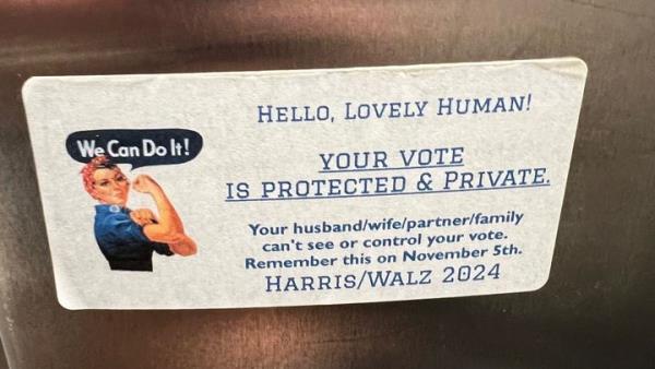 A sticker, spotted in a women's restroom at a Georgia airport, promotes Kamala Harris for president.