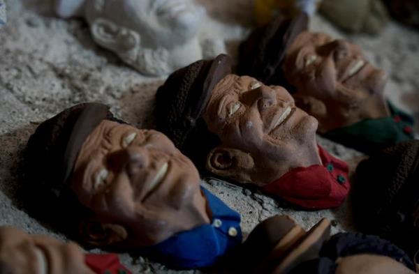 Masks created by artisan William Luna to adorn a sweet bread called tantawawa, traditio<em></em>nal for Day of the Dead celebrations, are set on a table at his workspace, in La Paz, Bolivia.