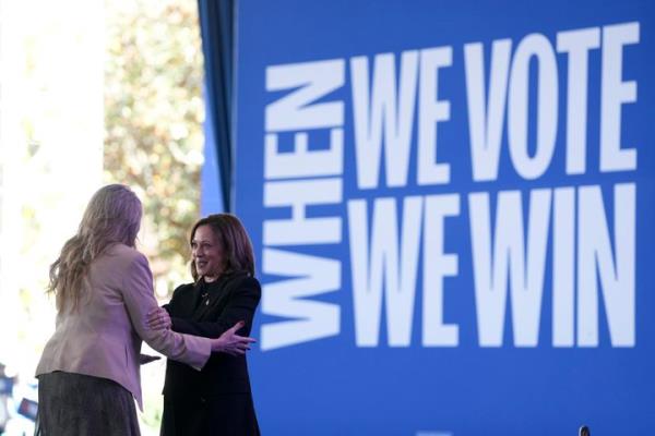 Democratic presidential nominee Vice President Kamala Harris is greeted by Jennifer Bell, as she arrives to speak at a rally at the Coastal Credit Unio<em></em>n Music Park at Walnut Creek in Raleigh, North Carolina, on Wednesday.