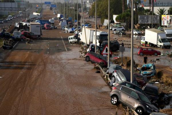 Vehicles are seen piled up after being swept away by floods on a motorway in Valencia, Spain.