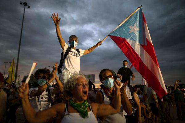 People march along Las Americas Highway in October 2021 to protest co<em></em>ntinued blackouts years after Hurricane Maria in San Juan, Puerto Rico.