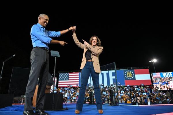 Former President Barack Obama holds hands with Democratic presidential nominee Kamala Harris during a campaign rally in Georgia, a battleground state.