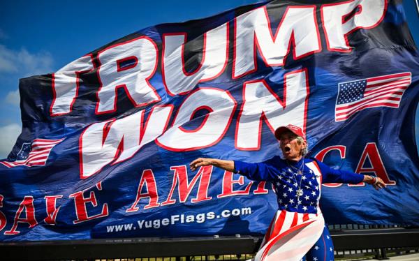 Supporters of former US president and Republican presidential candidate Do<em></em>nald Trump celebrate his victory near his Mar-a-Lago resort in Palm Beach, Florida, on November 6, 2024. - Do<em></em>nald Trump won a sweeping victory Wednesday in the US presidential election, defeating Kamala Harris to complete an asto<em></em>nishing political comeback that sent shock waves around the world. (Photo by CHANDAN KHANNA / AFP)