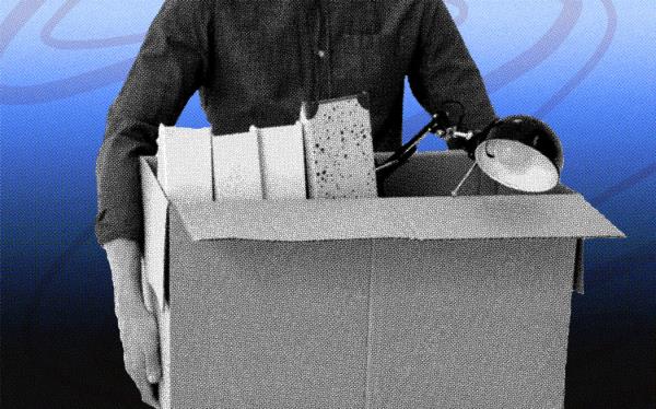 Someone carrying office items in a cardboard box