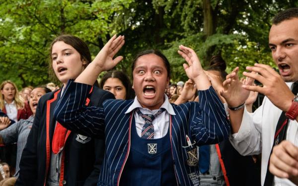 School students perform a haka during a vigil in Christchurch on March 18, 2019.