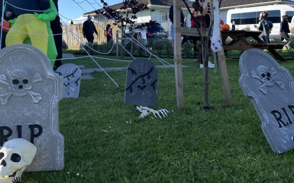 A backyard repurposed as a graveyard for Halloween.