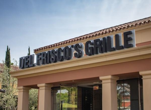 A view of a store front sign for the restaurant known as Del Frisco's Grille.