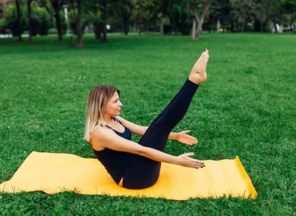 woman doing v-ups, co<em></em>ncept of HIIT exercises for belly fat