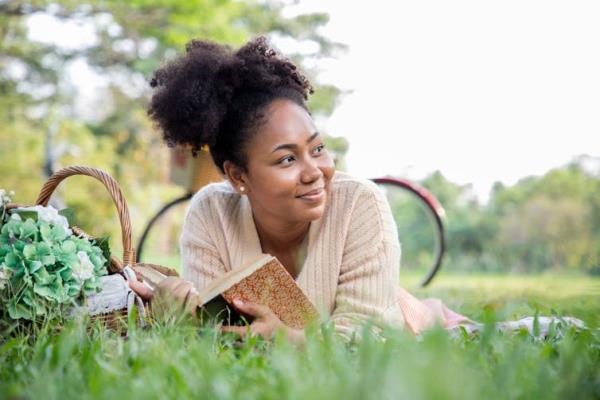 A young woman reads a book.