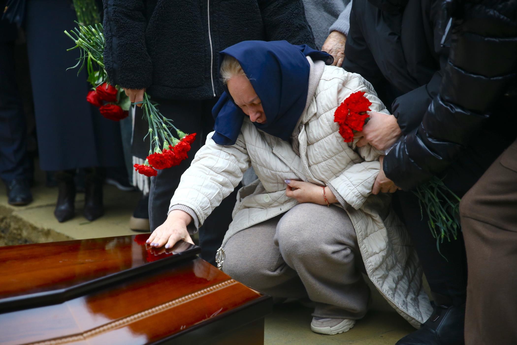 A family member of the Azerbaijan Airlines pilots who died in a crash Wednesday mourns during their burial, Baku, Azerbaijan, Dec. 29, 2024. (AA Photo)