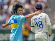 A pitch invader with Virat Kohli during the second day of the 4th Test between India and Australia. (AP Photo)