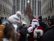 A man dressed as Santa stands in front of the Rockefeller Center Christmas Tree in Manhattan in New York City, US. (IMAGE: REUTERS)