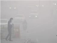 A man crosses a road amid dense fog in New Delhi (Photo: PTI)