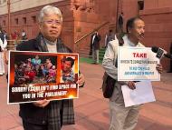 Dr Angomcha Bimol Akoijam, an MP from Manipur, holds a poster apologising to his people for his inability to raise the pressing issues of Manipur in the House. (News18)