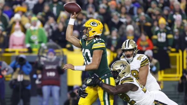 Green Bay Packers quarterback Jordan Love throws a ball under pressure against the New Orleans Saints