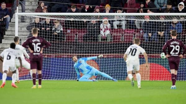 FC Petroclub's Victor Mudrac scores the penalty that ended Hearts' campaign