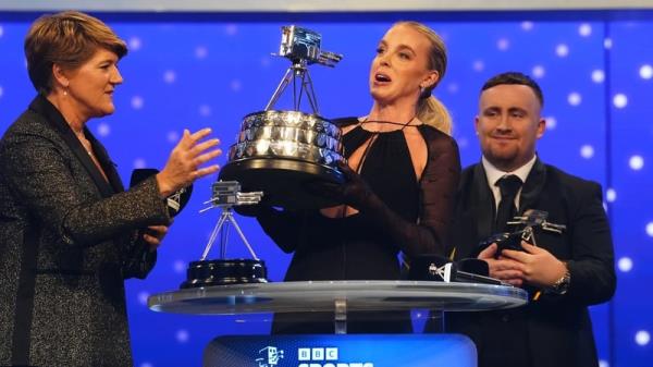 BBC's Sports Perso<em></em>nality of the Year Keely Hodgkinson hoists the trophy aloft at the awards ceremony in Salford