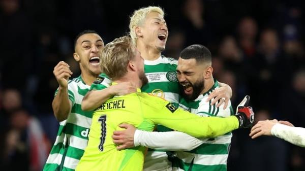 Celtic players celebrate as captain Callum McGregor lifts the Premier Sports Cup trophy