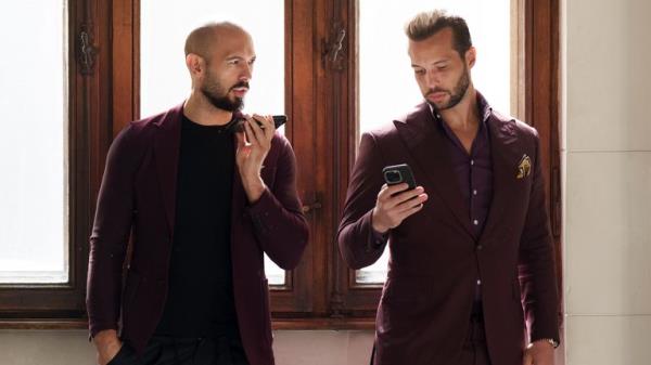 Andrew Tate and his brother Tristan wait at the Court of Appeals building in Bucharest, Romania.
Pic: AP