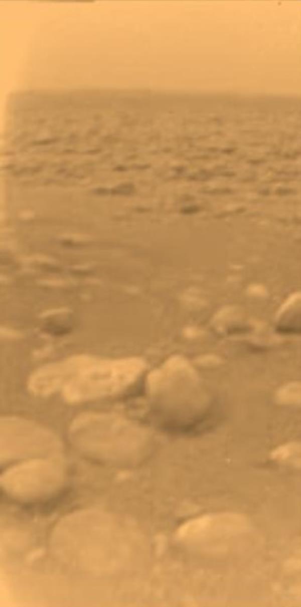 Yellowish ground with many rounded rocks of the same color under a yellow sky.