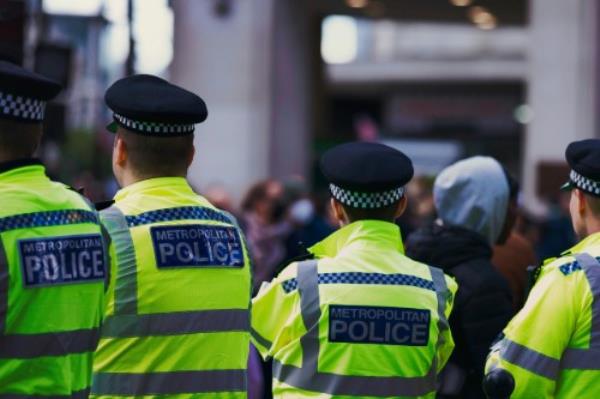 Image shows police officers on patrol in a busy street